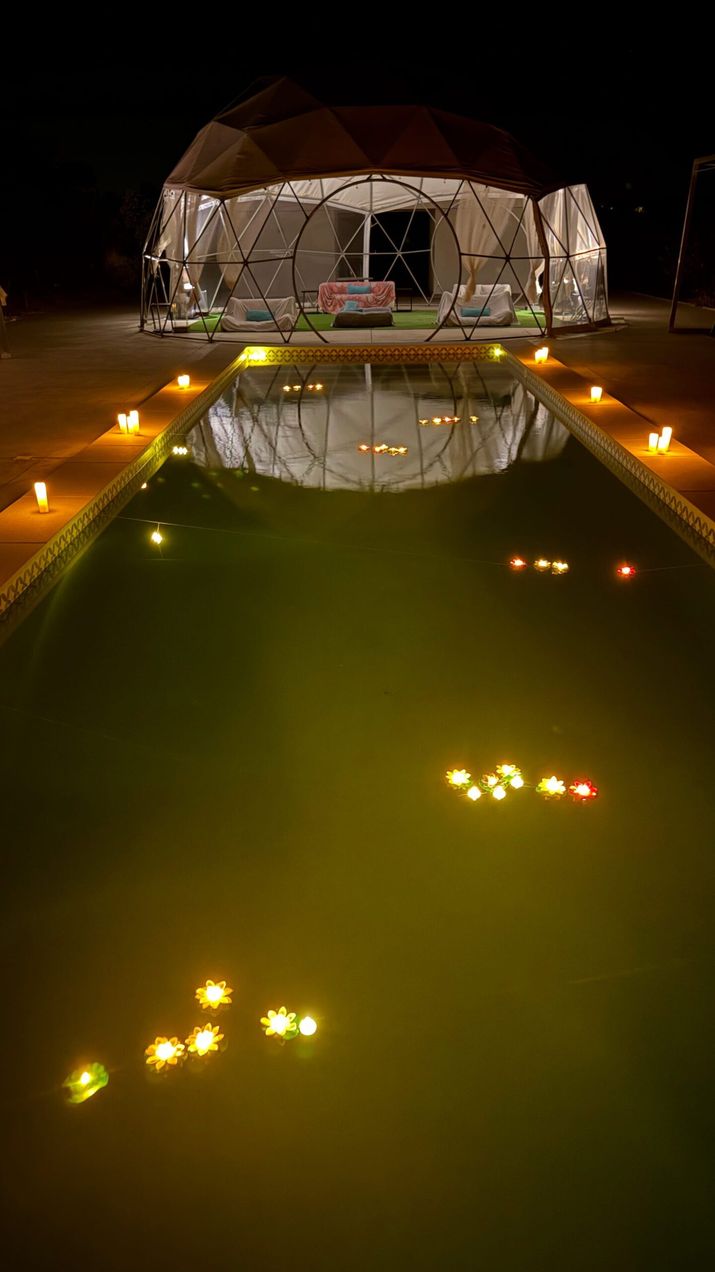 Floating flower lights on the pool at Glamping Skies during a romantic proposal